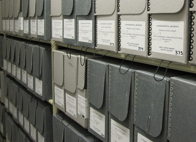 Rows of grey archival boxes on shelves
