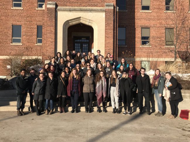 Group of Kings students standing in front of Shingwauk Hall, Algoma University.