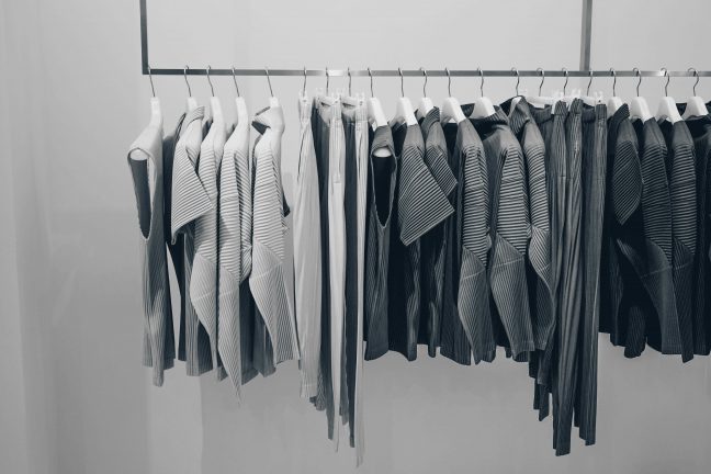 Hanging rack of grey clothes.