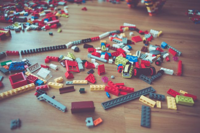 Assorted Lego on a wood floor.